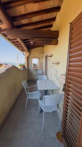 a patio with a table and chairs on a building at La Nobiltà del Tempo in Murlo
