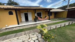 a house with a hammock in front of it at Kundalini Buzios in Búzios