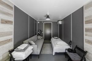 a living room with a couch and two beds at RUMMU Quarry Houses in Rummu