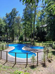 a swimming pool with a fence around it at Pucon dpto in Pucón