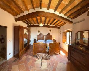 a bedroom with a bed and a wooden ceiling at La Nobiltà del Tempo in Murlo