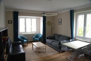 a living room with a couch and a table at Yapot in Colmar
