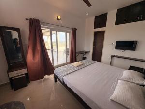 a bedroom with a bed and a large window at Ocean Kala Crest in Cheyūr +26 photos
