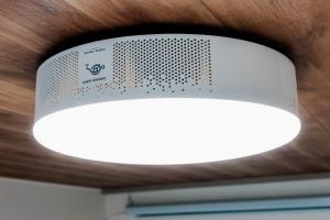 a white light hanging from a ceiling at 余韻 -YOIN- Kofu 甲府中心街で夜を楽しむ貸切宿 in Kofu