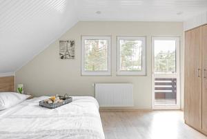 a bedroom with a bed with a bowl of fruit on it at Ośrodek Świt Wilga in Wilga +15 photos