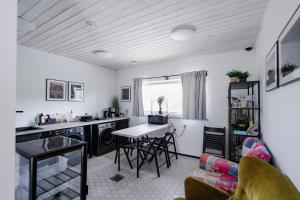 a kitchen and living room with a table and chairs at RUMMU Quarry Houses in Rummu +24 photos