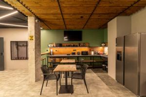 a dining room with a table and chairs and a kitchen at O'clock bed & SPA in Burgas