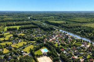 an aerial view of a village with a river at The Poplar Place - Spacious Comfort, Hot Tub in Private Garden in Zeewolde