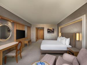 a hotel room with a bed and a couch at NG Afyon Wellness & Convention in Afyon