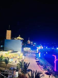 a city at night with a street and buildings at Saka Hotel in Plei Brel (2)
