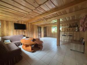 a living room with a couch and a table at Gostynnyi Dvir u Marichky in Lazeshchyna