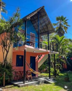 a house with a hammock in front of it at Cajibá Imbassai in Imbassai