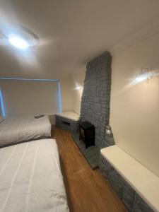 a room with two beds and a stone wall at Newbridge house in Newbridge