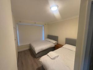 a small room with two beds and a window at Newbridge house in Newbridge +10 photos