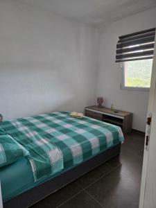 a bedroom with a bed and a table and a window at Ignjic Apartmani in Buljarica
