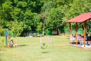 a park with a gazebo and benches in the grass at Rečni Povetarac in Niš