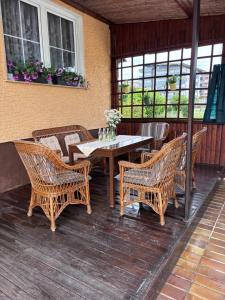 a wooden table and chairs on a deck at Apartma Rožman in Radenci