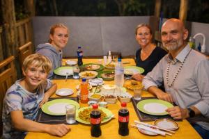 a group of people sitting at a table at The Rock & Paddy Resort in Sigiriya