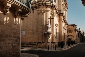 a building with a statue on a pole in front of it at Casa Radiant in Rabat