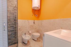 a bathroom with a toilet and a sink at Magnifica Terrazza - Lake View & Wi-Fi in Gardone Riviera +19 photos