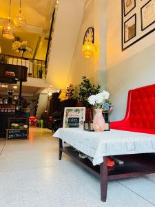 a room with a red bench and a table at Baan Bangrak Home in Bang Rak +50 photos