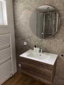 a bathroom with a sink and a mirror at Chalet FoRest Veluwe with private hottub & incl wood! in Putten +24 photos