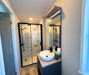 a bathroom with two sinks and a shower at Hilltop Holiday Park in Portrush