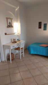 a bedroom with a desk and a bed at Myrto Signature Suite - Aegina in Aegenitissa