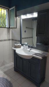 a bathroom with a sink and a mirror at Myrto Signature Suite - Aegina in Aegenitissa