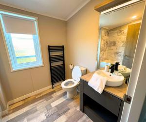 a bathroom with a sink and a toilet at Hilltop Holiday Park in Portrush