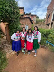 a group of four women posing for a picture at Kusk'a Lodge in Puno
