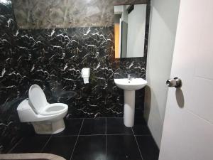 a bathroom with a toilet and a sink at Kusk'a Lodge in Puno