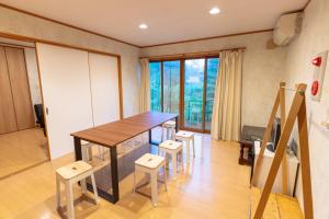 a dining room with a table and some chairs at 灯ノ環tomonowa in Mitsuwa
