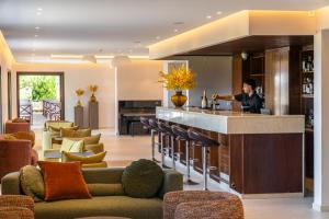 a kitchen and living room with a person standing in the kitchen at Hotel Delfinia in Mythimna