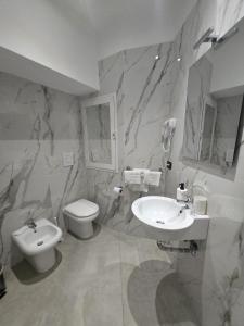 a bathroom with a toilet and a sink at Hotel Living in Casoria