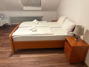 a bedroom with a bed with two towels on it at Hotel Restaurant Warndtperle in Völklingen