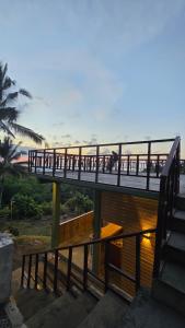 a bridge with people walking on it over the water at Bale Sunset Inn in Senaru +36 photos