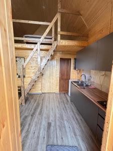 a kitchen with wooden floors and a staircase in a house at Lake Tsover in Dsegh +3 photos