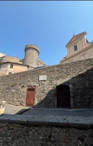 a stone wall with a building in the background at Vega Suite in Bracciano +6 photos