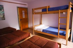 a bedroom with two bunk beds and a bed at AU CHAT BLEU in Saint-Laurent-les-Bains