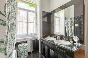 a bathroom with two sinks and a window at Sky Accommodations family Studios and Suites in Coimbra +75 photos