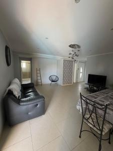 a living room with a couch and a table at Location Vias in Vias