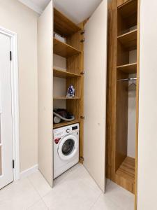 a laundry room with a washer and dryer at Lux Residence 3 in Osh