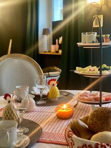 a table with a table set with food and candles at Pension Gablenz in Chemnitz