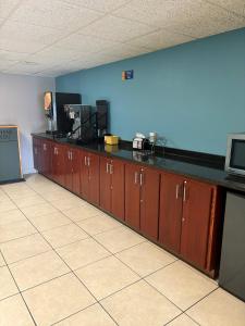 a room with a long line of wooden cabinets at Days Inn by Wyndham St Cloud in Saint Cloud