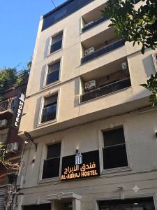 a building with a sign on the side of it at Hotel Al Abraj in Oran