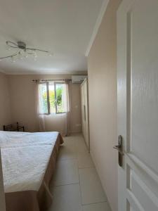 a bedroom with a large bed and a window at Location Vias in Vias +6 photos
