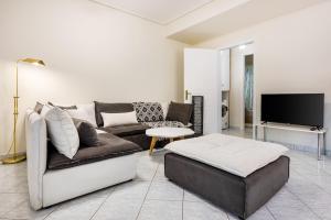 a living room with a couch and a tv at Pallantides Residence in Pallini
