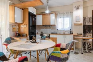 a kitchen with a table and chairs in a room at Pallantides Residence in Pallini