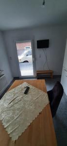 a living room with a table with a remote control on it at Carodorfblick in Carolinensiel